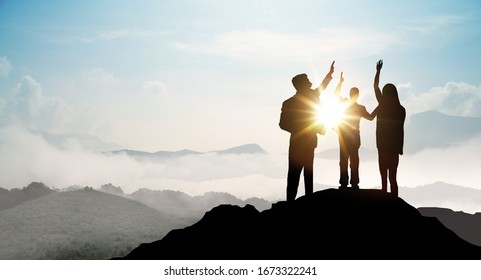 Silhouette of Business team show arm up on top of the mountain. Leadership and success Concept. - Shutterstock ID 1673322241