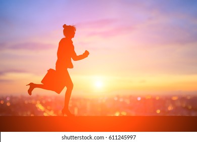 Silhouette Of Business Woman Running With Sunset