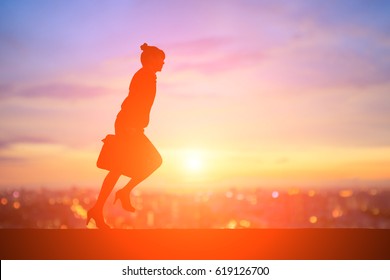 Silhouette Of Business Woman Running With Sunset