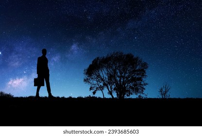 Silhouette of a businessman against the background of the starry sky - Powered by Shutterstock