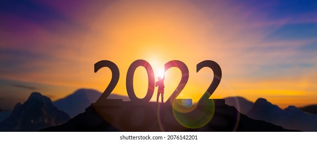 Silhouette Businessman Celebrating Raising Arms Between Word 2022 With Sunset Sky At Mountain And Number Like 2022 Abstract Background.concept Of Start With Strategy,plan,goal And Objective Target.