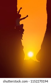 Silhouette Of Businessman Celebrating Success On Top Mountain, Sky And Sun Light Background. Business, Successful, Leadership, Achievement And Goal Concept. Adrenaline, Strenght, Ambition, Strategy.