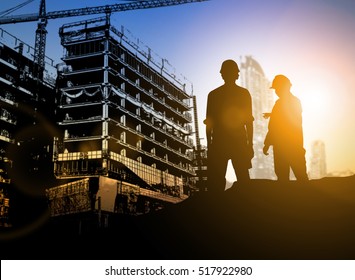 silhouette Businessman engineer looking blueprint in a building site over Blurred construction site film grain progress and potential personal and career growth concepts.
