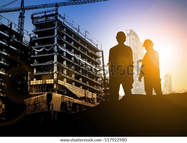 silhouette\
Businessman engineer looking blueprint in a building site over\
Blurred construction site film grain progress and potential\
personal and career growth\
concepts.