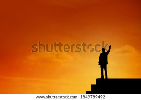 Silhouette of  Businessman stand on the top of stairs , archievement , success and leadership , hight level of team