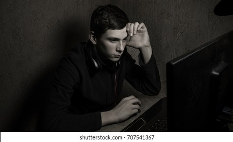 Silhouette Of Businessman Using Computer.
A Young Guy Working At A Computer