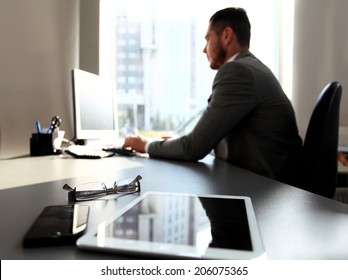 Silhouette of businessman using laptop in office  - Shutterstock ID 206075365