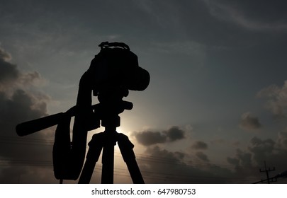 silhouette camera background sunset