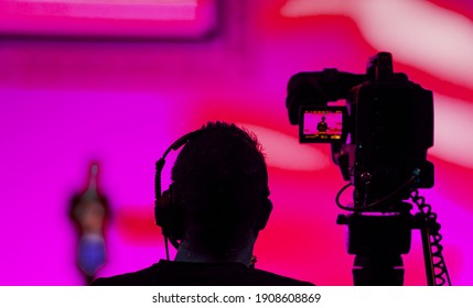 Silhouette of a Cameraman and Video Camera at live broadcast news event 