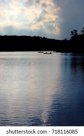 Silhouette Of Canoes With Sun Setting In Background At Joe Perry Lake, Bon Echo 