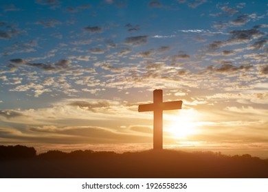 Silhouette of catholic cross, Crucifixion of Jesus christ at sunset background.