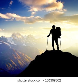 Silhouette of a champion on the high mountain. Sport and active life
