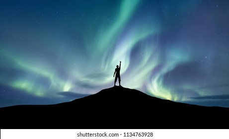 Silhouette of a championat the northen light background. Sport and active life concept and idea of success