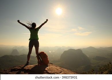 Silhouette Of Cheering Woman Hiker Open Arms At Mountain Peak