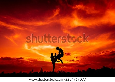 Silhouette of children fighting in Thailand.Muay Thai, Thai Fight. Thai Boxing.on sunset background.select focus.
