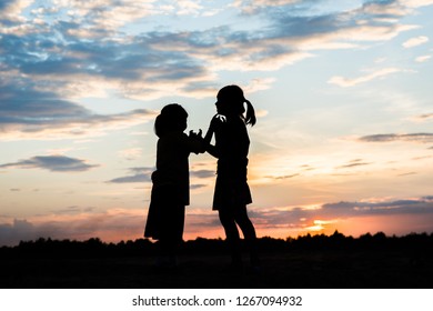 Silhouette of children playing  - Shutterstock ID 1267094932