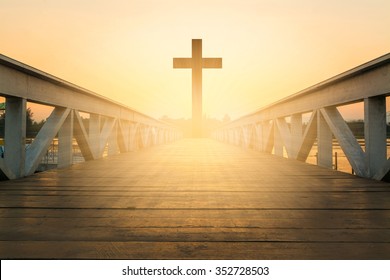 silhouette christian cross at railhead wooden bridge and orange sky with lighting,religion concept - Shutterstock ID 352728503