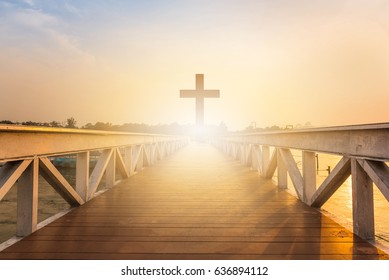 Silhouette christian cross at railhead wooden bridge and orange sky with lighting,religion concept. - Shutterstock ID 636894112