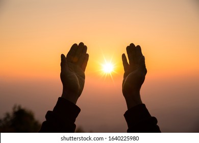 Silhouette of christian man hand praying, spirituality and religion, man praying to god. Christianity concept.