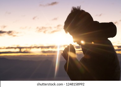 Silhouette of christian man hand praying,spirituality and religion,man praying to god. Christianity concept.  - Shutterstock ID 1248158992