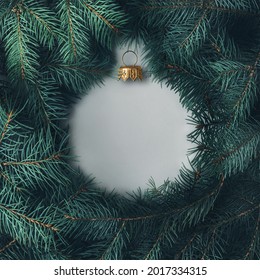 Silhouette Of A Christmas Ball Made Of Pine Branches. Creative Christmas Layout. 