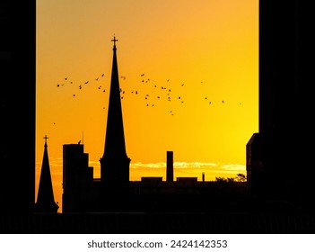 Silhouette of church steeple at sunset
