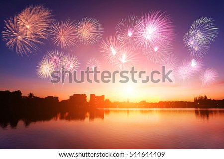Silhouette city urban communities with soft focus sunset and colorful fireworks background. Blurred blue purple sky peaceful glow bright during twilight. Outdoor water open view. Landscape celebration