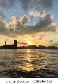 Silhouette Of Cityscape Of Kowloon, Hog Kong And Victoria Harbour During Sunset