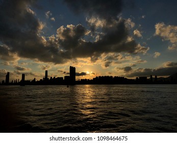 Silhouette Of Cityscape Of Kowloon, Hog Kong And Victoria Harbour During Sunset