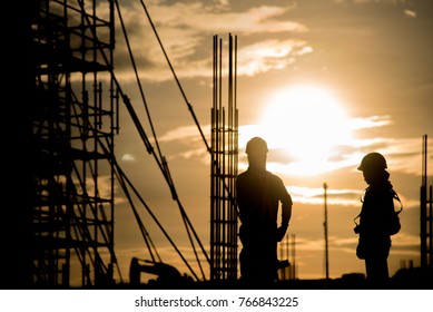 Silhouette civil site engineer and construction worker working on scaffolding in industrial construction during sunset sky background over time job - Shutterstock ID 766843225