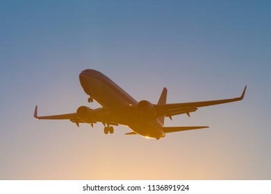 silhouette of a civilian aircraft at sunset