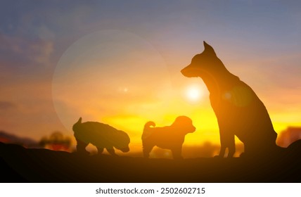 A silhouette concept of dog family, sitting dog and puppy playing on the ground with blur sunset background computer graphic light, homeowner pet and animal, copy space for individual text and design - Powered by Shutterstock