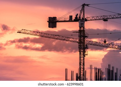 silhouette construction crane on dramatic sky background