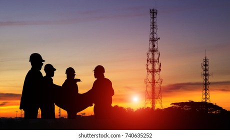 Silhouette Construction Engineer Standing Orders For Worker Team Looking Telecommunication Mast Television At Sunset, Teamwork Concept