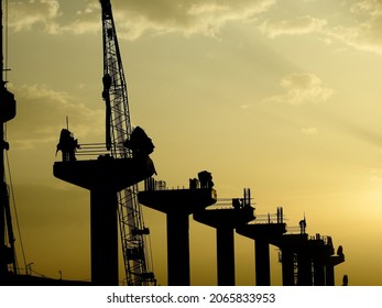 A Silhouette of a construction site of Cairo Monorail which is a two-line monorail over road rapid transit system currently under construction, elevated rail for people transport.