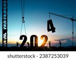 Silhouette of construction worker with crane and cloudy blue sky for preparation of welcome 2024 new year party and change new business.
