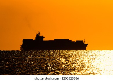 Silhouette Of A Container Ship On The Background Of The Morning Sky