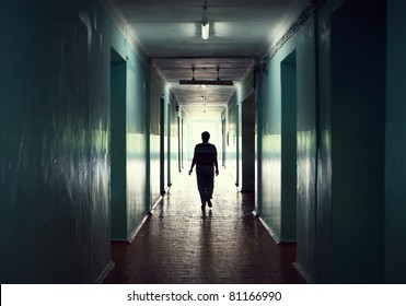 silhouette in a corridor. Light at the end of the tunnel concept - Powered by Shutterstock