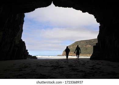 Silhouette Of A Couple Inside The Remarkable Cave Tasman National Park Tasmania Australia. Real People. Copy Space