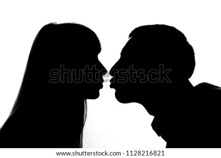 Similar – Man and woman face each other and look each other in the eyes