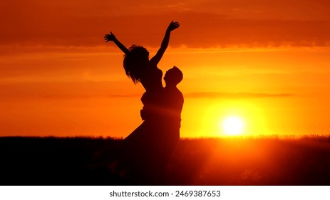 Silhouette of a couple in love in glamor romance at sunset. Love story concept. - Powered by Shutterstock