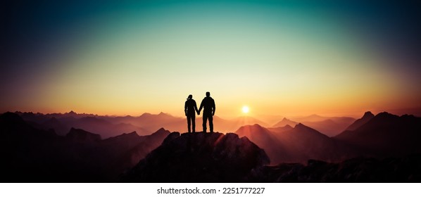 Silhouette Couple of man and woman reaching summit enjoying freedom and looking towards mountains sunset. Alps, Allgaeu, Bavaria, Germany. - Powered by Shutterstock