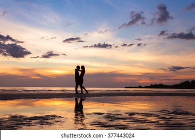 Silhouette Of Couple On Sunset Beach, Beautiful Background About Love And Relationships, Man And Woman