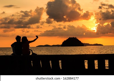 silhouette of couple at Pak Meng beach in Trang province, Thailand