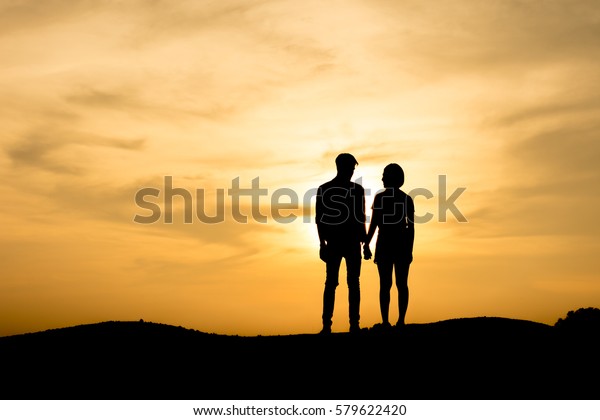 Silhouette Couple Standing On Mountain Sunset Stock Photo (Edit Now ...