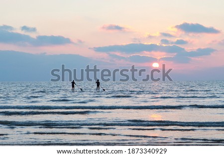 Image, Stock Photo people silhouettes on North sea beach at low tide