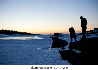 A Silhouette Of A Couple Walking Away From Each Other.