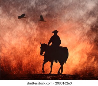 A Silhouette Of A Cowboy On His Horse Rides Into The Fire With Birds Flying Above.