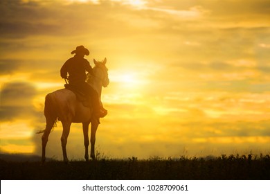   Silhouette Cowboy on horseback. Ranch - Shutterstock ID 1028709061