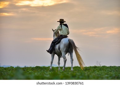  Silhouette Cowboy On Horseback. Ranch